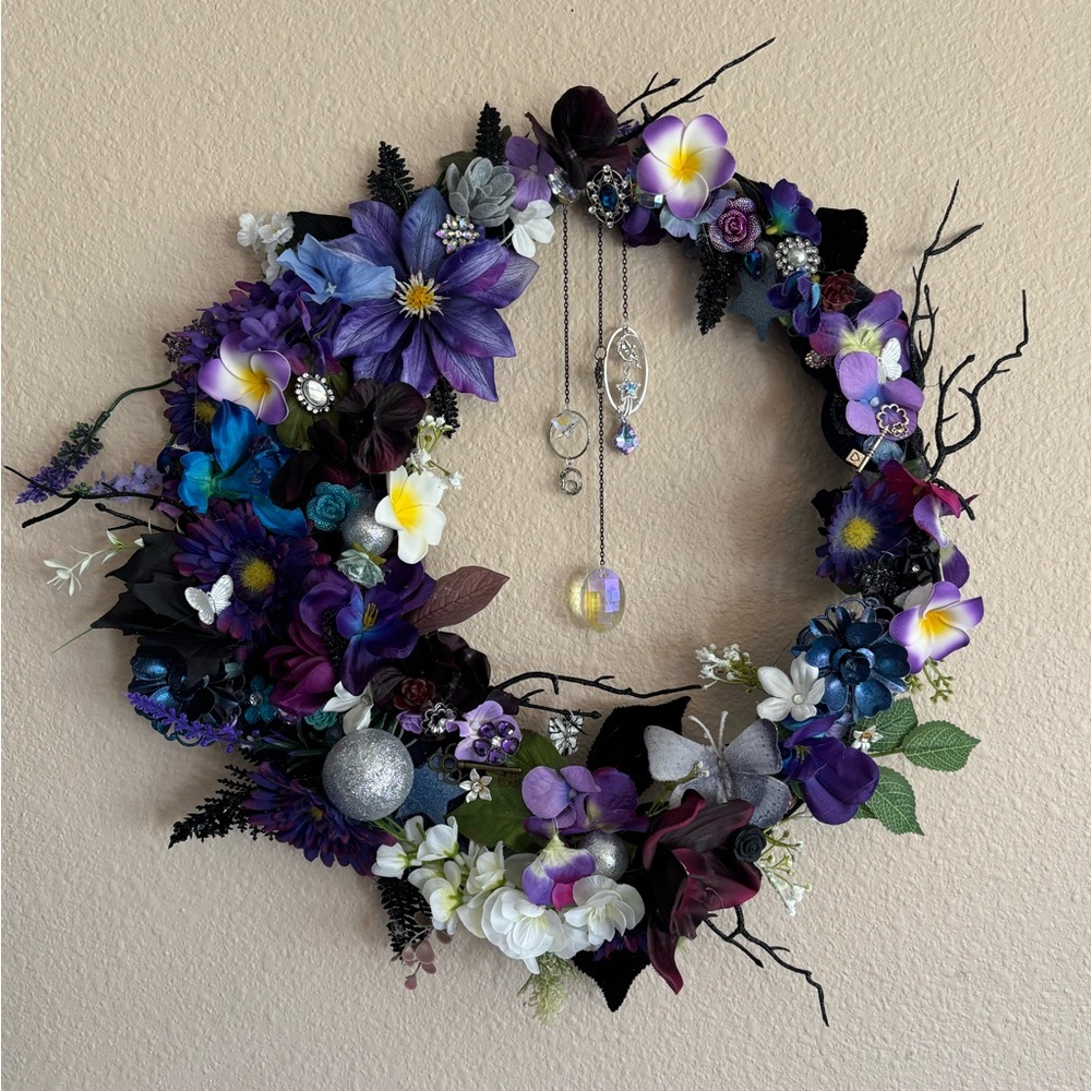 Moon shaped floral wreathe complete with light catchers and a touch of sparkle.